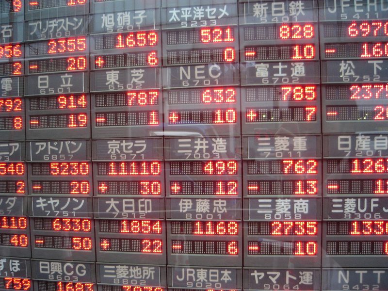 Red digits on an electronic stock quote board in Tokyo