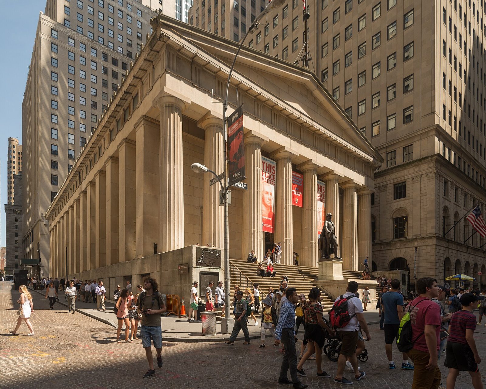 The Greek revival columns of Federal Hall with people on its steps
