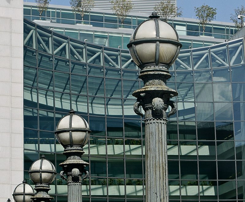 Street lamps in front of the glass facade of the SEC headquarters