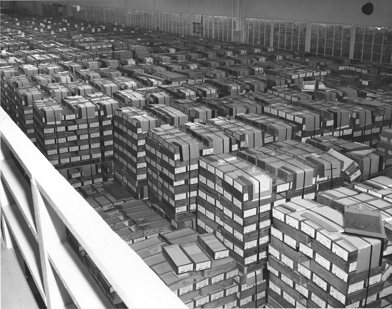 Rows of boxed punched cards stretching across a records warehouse