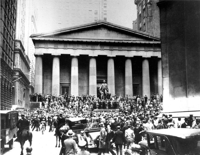 Black and white photograph of crowds filling Wall Street in 1929